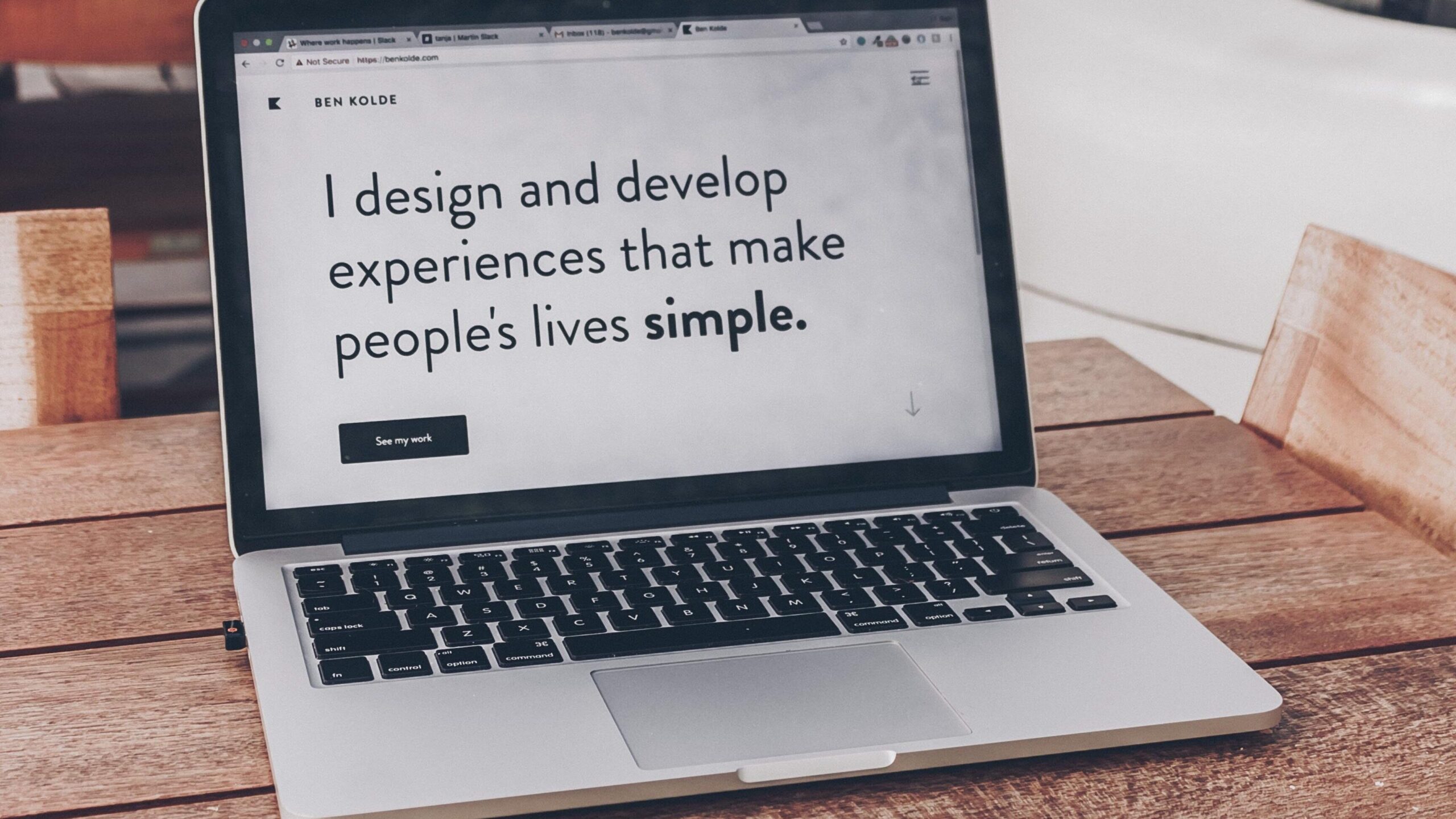 Laptop with text, "I design and develop experiences that make people's lives simple"