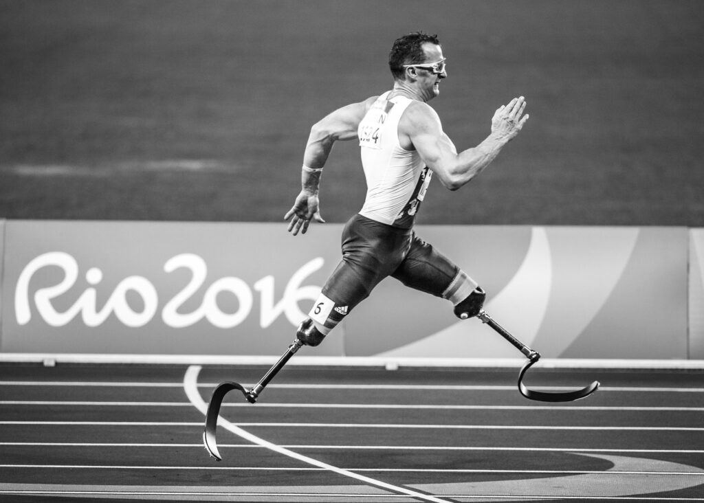 Amputee Athletic man running on a track.